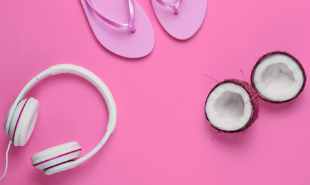 Flip flop with headphones, coconut on pink background. Summertime relax. Summer vacation. Beauty and fashion. Top view. Flat layの写真素材