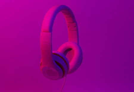 Classic wired headphones with gradient blue pink neon light. Retro style.Retro wave. 80s. Minimalistic music concept.の写真素材