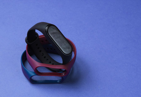 Smart watch with interchangeable bracelets on purple background. Fitness tracker. Modern gadgetsの写真素材