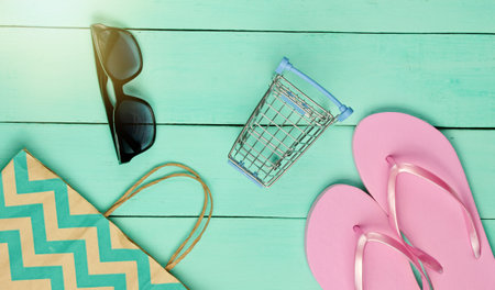 Summertime sale. Shopping concept. Summer beach accessories(flip flops, sunglasses), mini shopping...