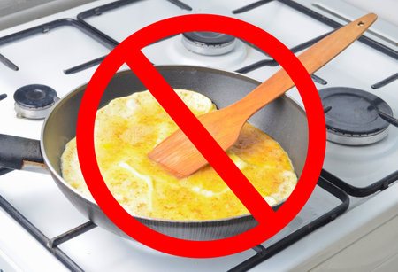 Fried egg-omelette from chicken eggs in a frying pan on the stove with prohibition sign.の写真素材