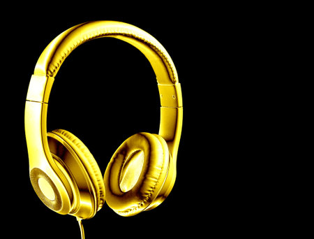 Golden headphones isolated on black background.の写真素材