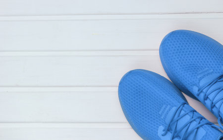 Blue sports shoes for running on white wooden floor. Top view.の写真素材