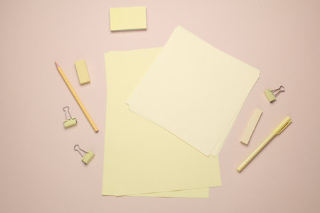 Paper sheets and Stationery set on beige background. Back to school, education, office supplies....