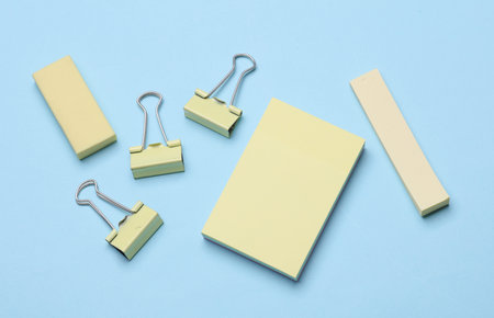 Yellow Stationery set on blue background. Back to school, education, office supplies. Flat lay. Top view. Creative layoutの写真素材