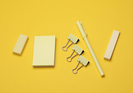 Yellow Stationery set on yellow background. Back to school, education, office supplies. Flat lay....