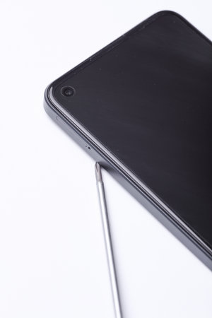 Phone repair, service maintenance. Smartphone with screwdriver on white background