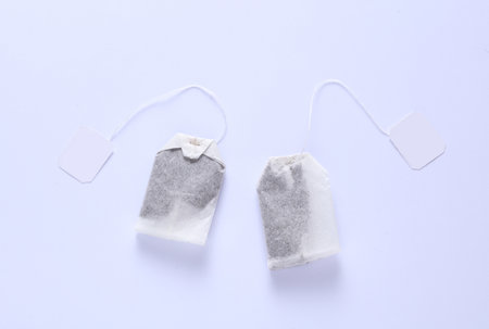 Tea bags with white labels on strings, white background. Mockup for design, brandingの写真素材