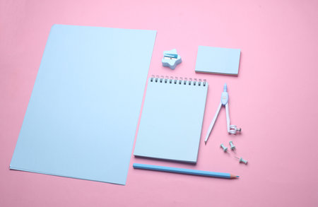 Blue Stationery set on pink pastel background. Back to school, education, office supplies. Flat lay. Top view. Creative layoutの写真素材