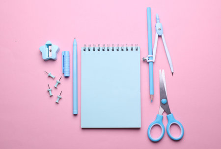 Blue Stationery set on pink pastel background. Back to school, education, office supplies. Flat lay. Top view. Creative layoutの写真素材