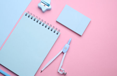 Blue Stationery set on pink pastel background. Back to school, education, office supplies. Flat lay. Top view. Creative layoutの写真素材