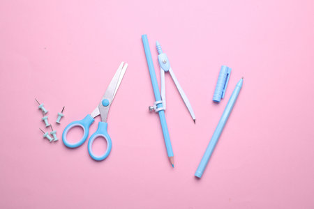 Blue Stationery set on pink pastel background. Back to school, education, office supplies. Flat lay. Top view. Creative layoutの写真素材