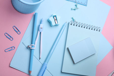 Blue Stationery set on pink pastel background. Back to school, education, office supplies. Flat lay. Top view. Creative layoutの写真素材