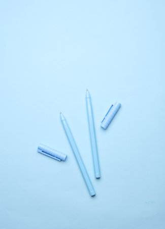 Blue Stationery set on light blue background. Back to school, education, office supplies. Monochrome photo. Flat lay. Top view. Creative layoutの写真素材