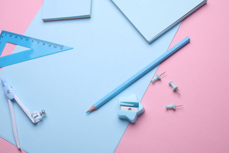 Blue Stationery set on pink pastel background. Back to school, education, office supplies. Flat lay. Top view. Creative layoutの写真素材