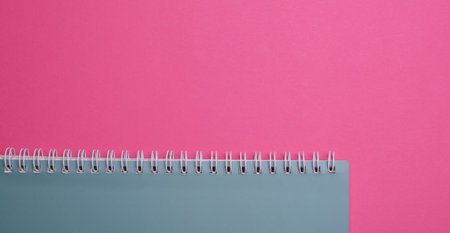 Spiral notebook on a pink backgroundの写真素材