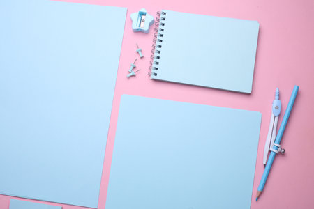 Blue Stationery set on pink pastel background. Back to school, education, office supplies. Flat lay. Top view. Creative layoutの写真素材