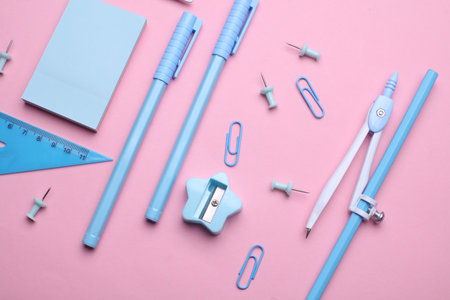 Blue Stationery set on pink pastel background. Back to school, education, office supplies. Flat lay. Top view. Creative layoutの写真素材