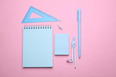Blue Stationery set on pink pastel background. Back to school, education, office supplies. Flat lay. Top view. Creative layoutの写真素材