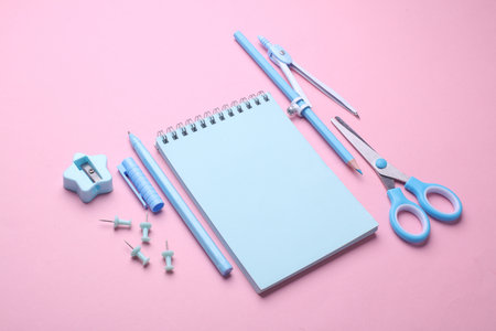 Blue Stationery set on pink pastel background. Back to school, education, office supplies. Flat lay. Top view. Creative layoutの写真素材