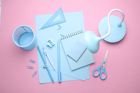 Blue Stationery set on pink pastel background. Back to school, education, office supplies. Flat lay. Top view. Creative layoutの写真素材