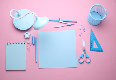 Blue Stationery set on pink pastel background. Back to school, education, office supplies. Flat lay. Top view. Creative layoutの写真素材