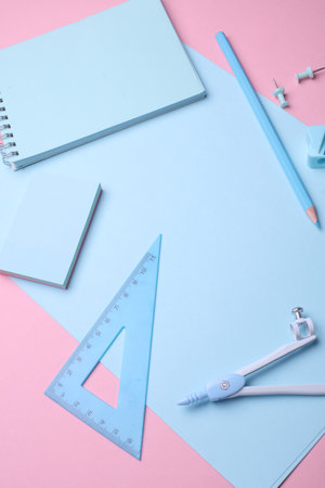 Blue Stationery set on pink pastel background. Back to school, education, office supplies. Flat lay. Top view. Creative layoutの写真素材