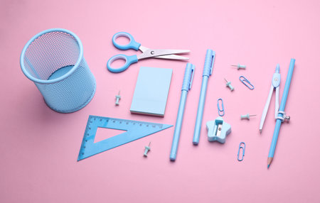 Blue Stationery set on pink pastel background. Back to school, education, office supplies. Flat lay. Top view. Creative layoutの写真素材