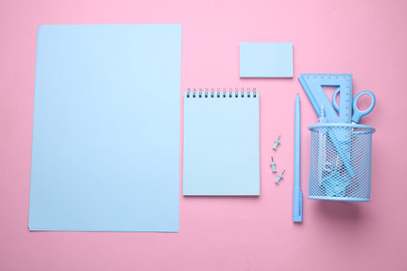 Blue Stationery set on pink pastel background. Back to school, education, office supplies. Flat lay. Top view. Creative layoutの写真素材