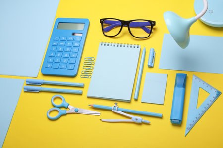 Blue Stationery set on yellow background. Back to school, education, office supplies. Flat lay. Top view. Creative layoutの写真素材