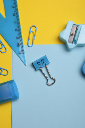 Blue Stationery set on yellow background. Back to school, education, office supplies. Flat lay. Top view. Creative layoutの写真素材