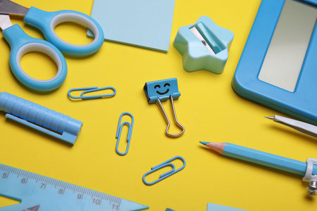 Blue Stationery set on yellow background. Back to school, education, office supplies. Flat lay. Top view. Creative layoutの写真素材