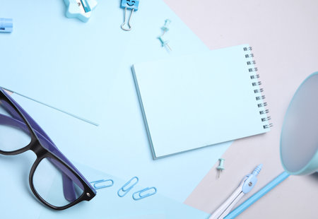 Blue Stationery set with paper sheets on gray background. Back to school, education, office supplies. Flat lay. Top view. Creative layoutの写真素材