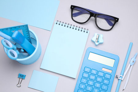 Blue Stationery set on gray background. Back to school, education, office supplies. Flat lay. Top view. Creative layoutの写真素材