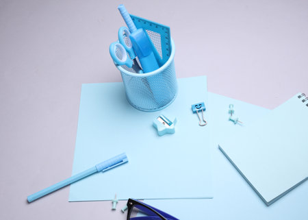 Blue Stationery set with paper sheets on gray background. Back to school, education, office supplies. Flat lay. Top view. Creative layoutの写真素材