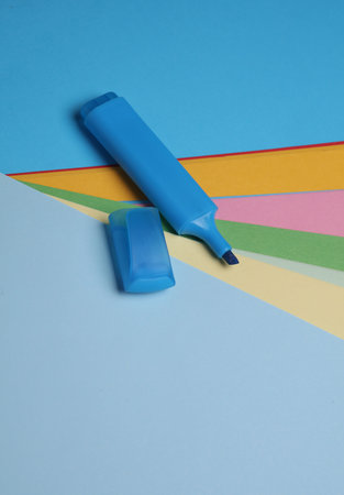 Blue felt-tip marker on colored sheets of paperの写真素材