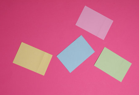 Set of colored memo stickers on pink backgroundの写真素材