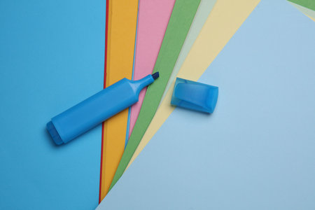 Blue felt-tip marker on colored sheets of paperの写真素材