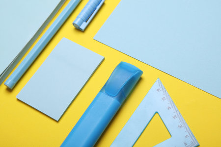 Blue Stationery set on yellow background. Back to school, education, office supplies. Flat lay. Top view. Creative layoutの写真素材