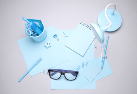 Blue Stationery set with paper sheets on gray background. Back to school, education, office supplies. Flat lay. Top view. Creative layoutの写真素材