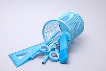 Bucket with blue stationery set on gray backgroundの写真素材