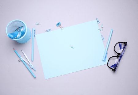 Blue Stationery set with paper sheets on gray background. Back to school, education, office supplies. Flat lay. Top view. Creative layoutの写真素材