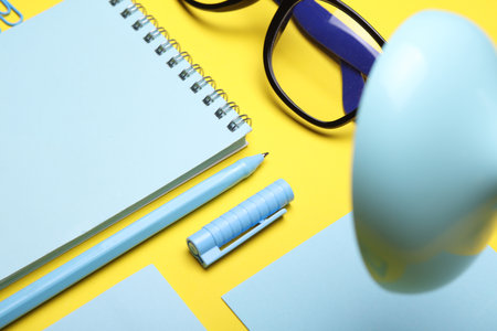 Blue Stationery set on yellow background. Back to school, education, office supplies. Flat lay. Top view. Creative layoutの写真素材