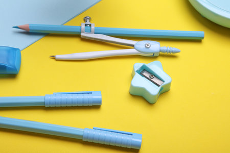 Blue Stationery set on yellow background. Back to school, education, office supplies. Flat lay. Top view. Creative layoutの写真素材