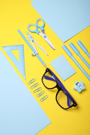 Blue Stationery set on yellow background. Back to school, education, office supplies. Flat lay. Top view. Creative layoutの写真素材