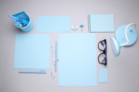 Blue Stationery set with paper sheets on gray background. Back to school, education, office supplies. Flat lay. Top view. Creative layoutの写真素材