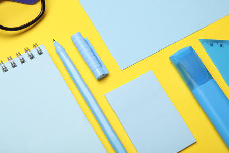 Blue Stationery set on yellow background. Back to school, education, office supplies. Flat lay. Top...