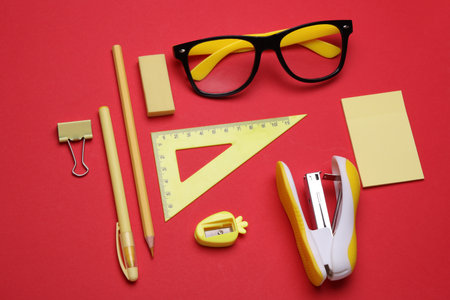 Stationery set on red background. Back to school, education, office supplies. Flat lay. Top view. Creative layoutの写真素材