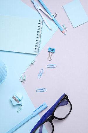 Blue Stationery set with paper sheets on gray background. Back to school, education, office supplies. Flat lay. Top view. Creative layoutの写真素材