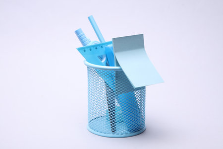 Bucket with blue stationery set on gray backgroundの写真素材